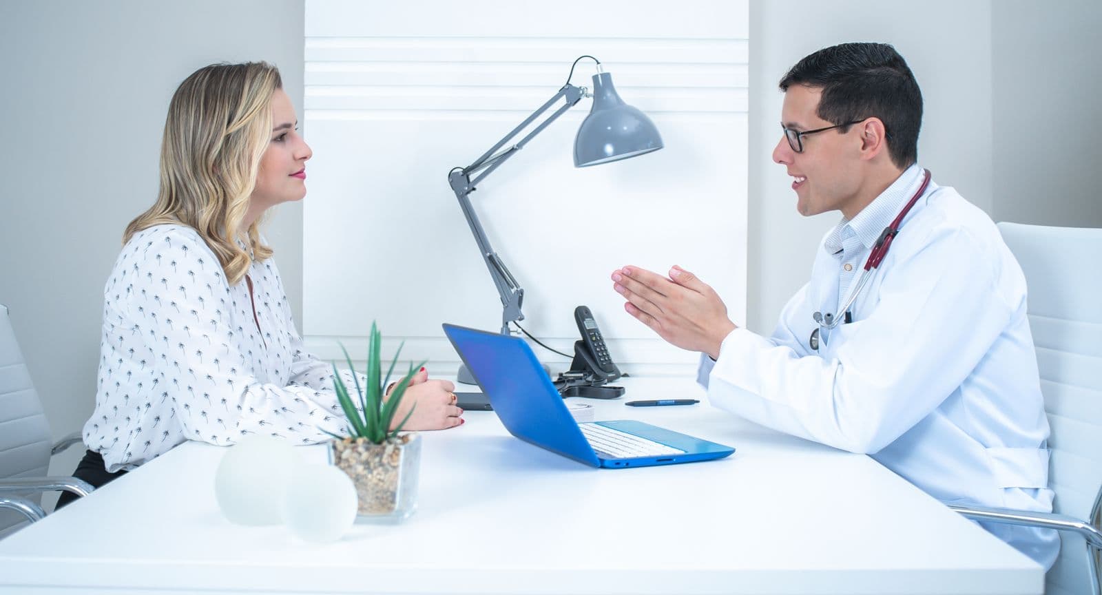 Doctor speaking with a patient in a bright consultation room